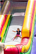 Child Sliding Down Inflatable Slide