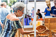 Woman Inspecting Wooden Bowl