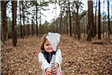 Child Holding a Seedling Tree in a Bag