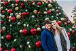 Couple Standing by Holiday Tree