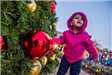 Young Child Standing Near Holiday Tree