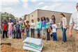 Children Standing with Bags of Soil