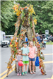 Children with Costumed Person on Stilts