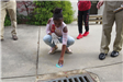 Child Labeling a Storm Drain
