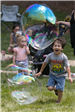 Children Chasing Large Bubbles