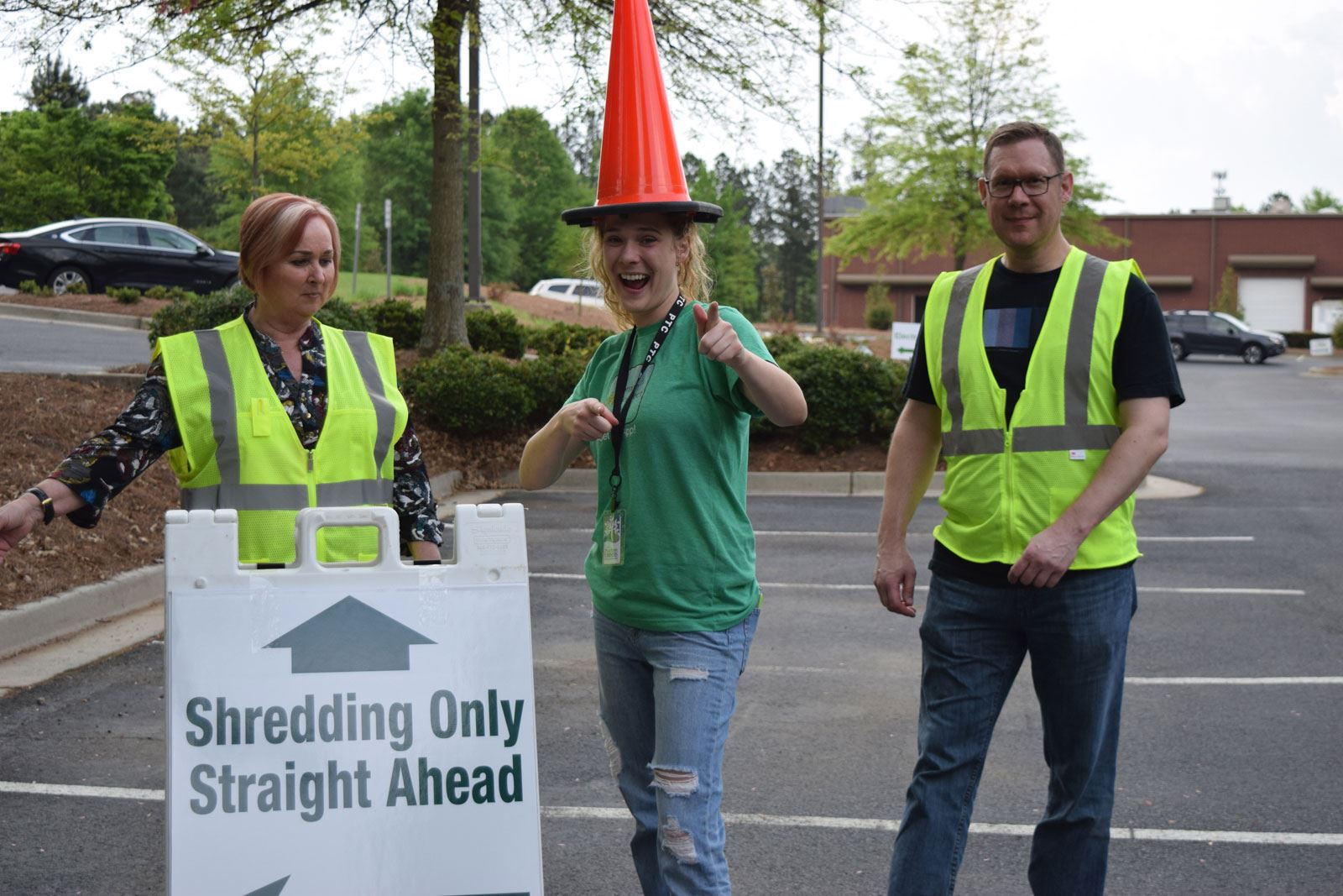 People Posing by Shredding Only Straight Ahead Sign