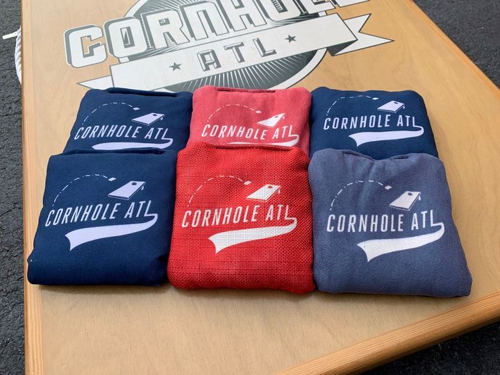 Photo of six cornhole bags on a cornhole board