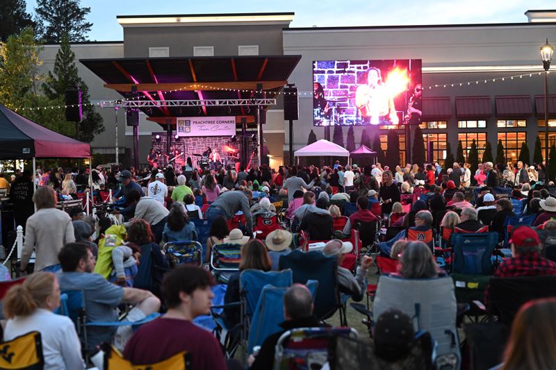 The audience and stage at an outdoor concert.