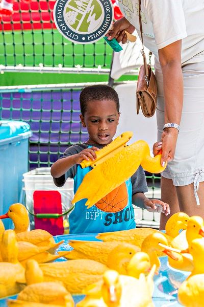 Child Looking at a Plastic Duck