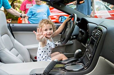 Small Child in Drivers Seat Waving