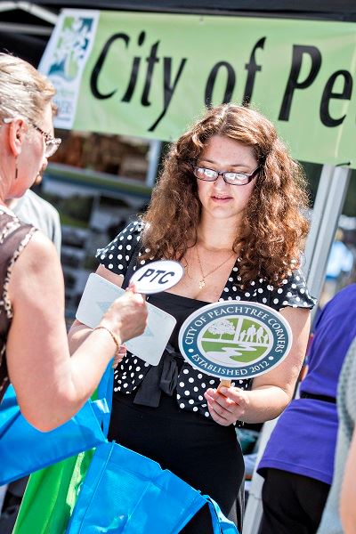 Woman Receiving Items at the Peachtree Corners Booth