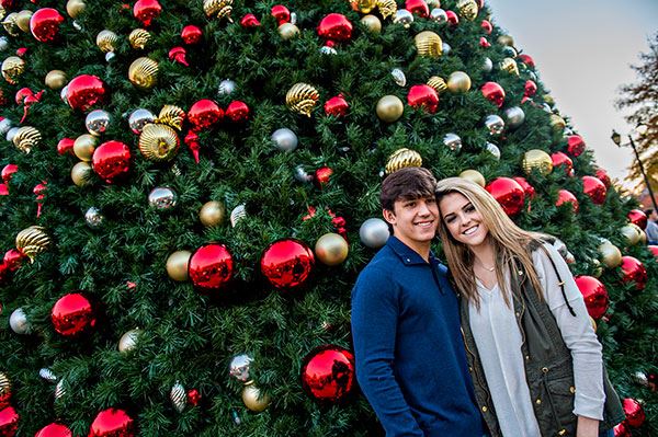 Couple Standing by Holiday Tree