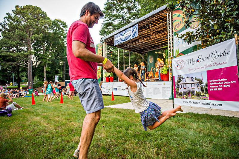 Man Swinging Young Child