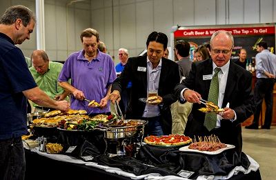People Making Plates of Finger Food From a Buffet