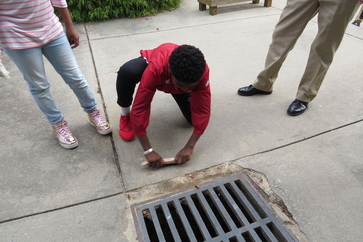 Child Brushing Concrete
