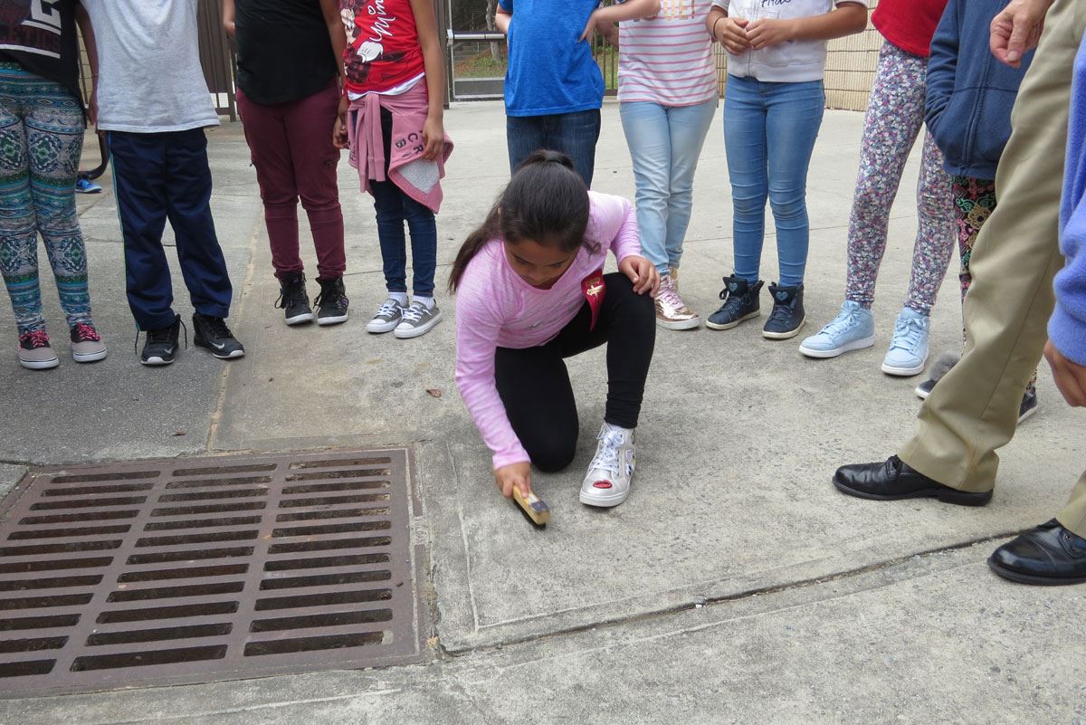 Child Brushing Concrete