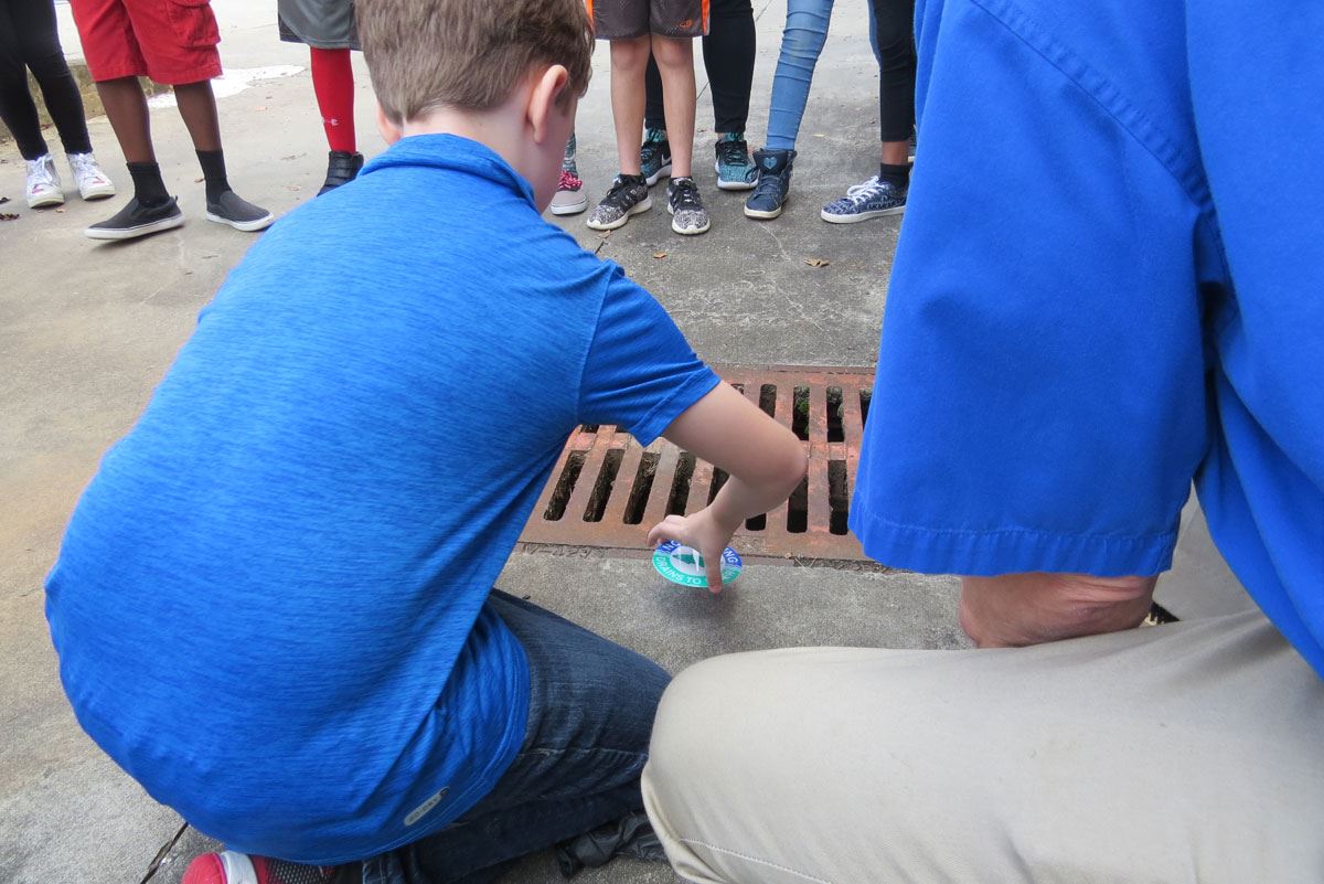 Child Labeling a Storm Drain