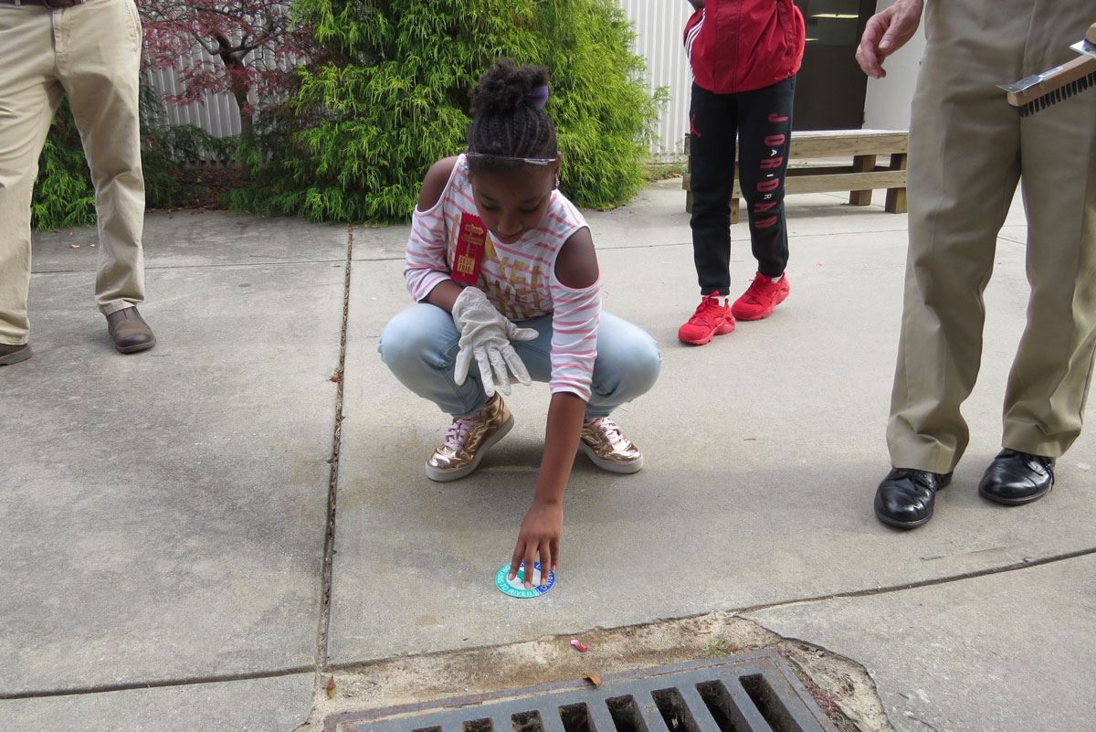 Child Labeling a Storm Drain