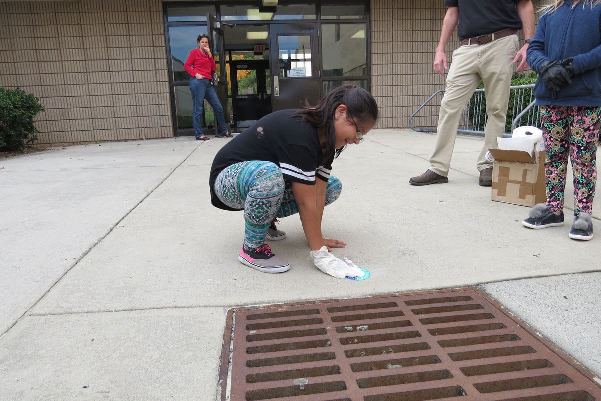 Child Labeling a Storm Drain