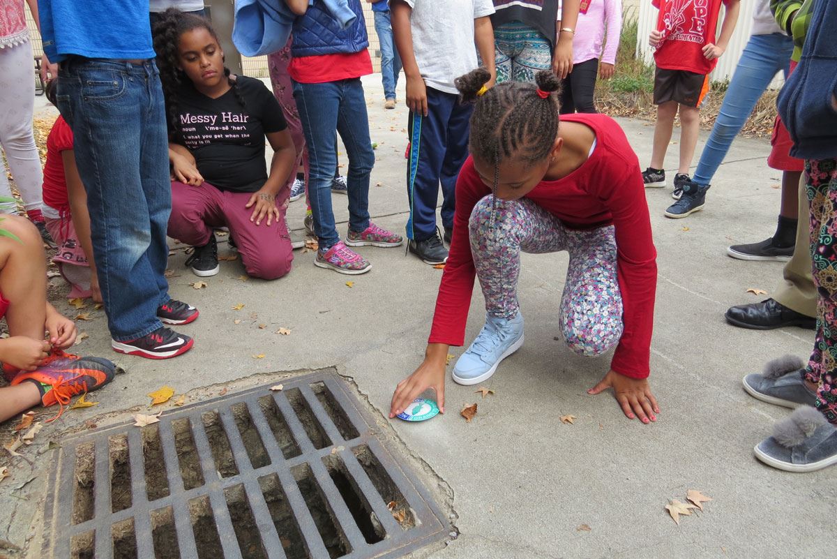 Child Labeling a Storm Drain