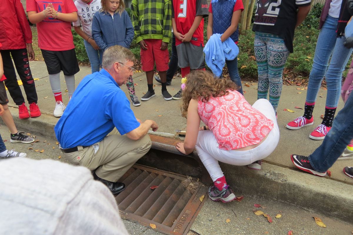 Child Preparing Drain for Label