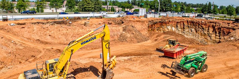 Machines working in a dirt pit