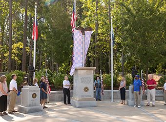 Mayor unveiling the eagle at the Veterans Monument